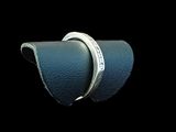 pair of silver wedding rings on a blue leather ring holder