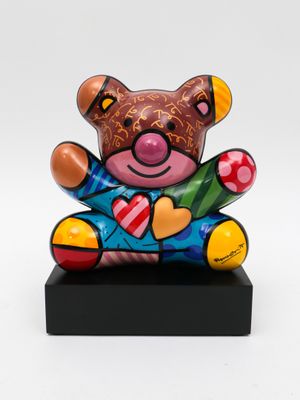 sculpture of a teddy bear sitting on top of a black base