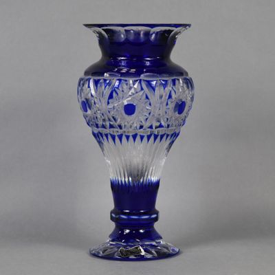 an image of a blue glass vase on a gray background