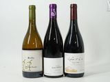 three bottles of wine sitting next to each other on a table
