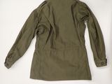 the back of a military jacket on a white surface