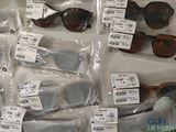 many pairs of sunglasses that are on display in the store