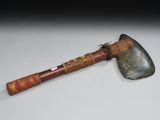 a close up of an old axe on a white surface