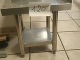 a stainless steel sink on a tile floor in a kitchen