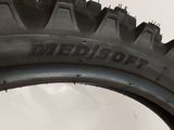 someone is holding a tire tire on a white surface
