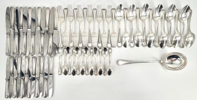 many forks and spoons laid out on the table