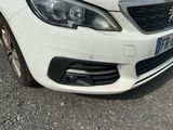 a white car that is parked on the side of the road