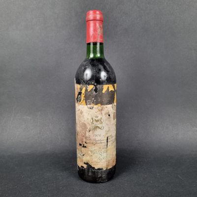 a bottle of wine with a red cap on a black background