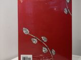 the book is sitting on a white table with a red cover