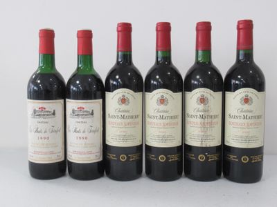 six bottles of wine are lined up in a row on a table