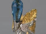 une image représentant une bague sertie d'une topaze bleue et ornée d'une feuille d'or