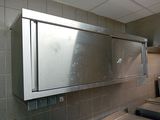 a stainless steel cabinet in the middle of a kitchen