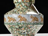 a vase that has a picture of giraffes on it
