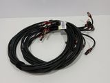 a close up of a pair of black wires on a white surface