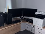 a computer desk with two monitors and a printer on it