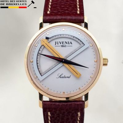 a close up of a wrist watch with a red strap