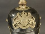 an old helmet with a gold decoration on top of it