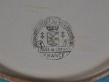 a plate with a picture of a coat of arms and a crown on it