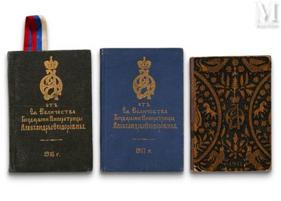 three books are lined up on a white surface with a blue ribbon