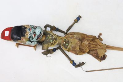 a dead doll on the ground with skis and poles