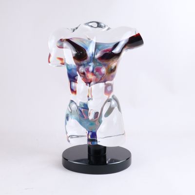 a glass sculpture of a male torso on a black stand