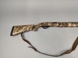 a rifle with a brown and black handle on a white surface