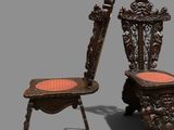 an image of a pair of carved chairs with a red seat