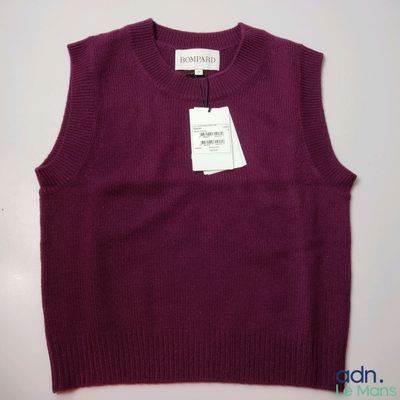 a purple sweater with a tag on the back of it