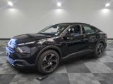 a black 2020 ford escape is shown in a showroom