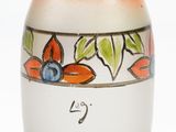 a vase with a flower design on it sitting on a table