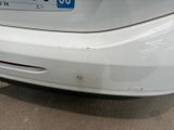 a close up of a white car with a number plate on it
