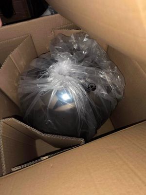 une boîte contenant une balle emballée dans du plastique