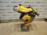 a close up of a yellow machine on a stand in a room