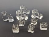 several pieces of clear acrylic cubes on a black surface