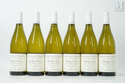 six bottles of white wine lined up in a row on a table