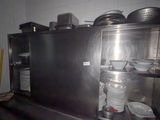 many plates and pans on the counter in the kitchen