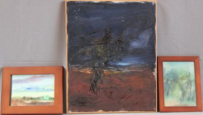 three paintings on a shelf next to two framed pictures