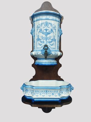 a blue and white water fountain on a wooden stand