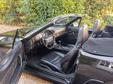 a picture of a black car with its door open