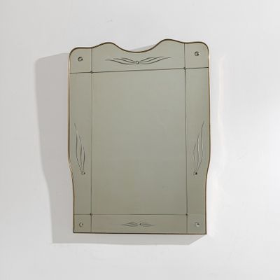 mirrored mirror with a scalloped edge and a curved frame
