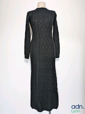 the dress is black and has long sleeves on it