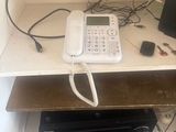 a picture of a desk with a phone and a laptop