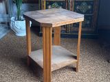 a small wooden table with a shelf on top of it
