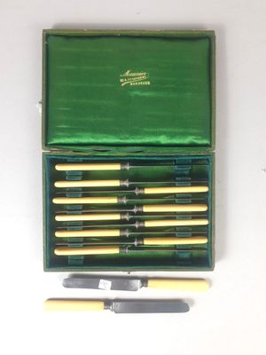 a green box with a set of six knives and a knife sharper