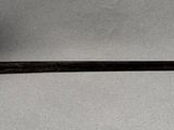 a sword with a gold handle on a white surface
