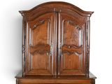 a large wooden cabinet with two doors on top of it
