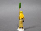 figurine of a man holding a green flag on a white base