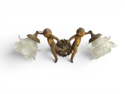 three bronze figurines of women with flowers on a white background