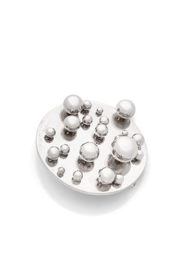 an image of a white plate with silver balls on it