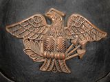 a black helmet with a gold eagle on it